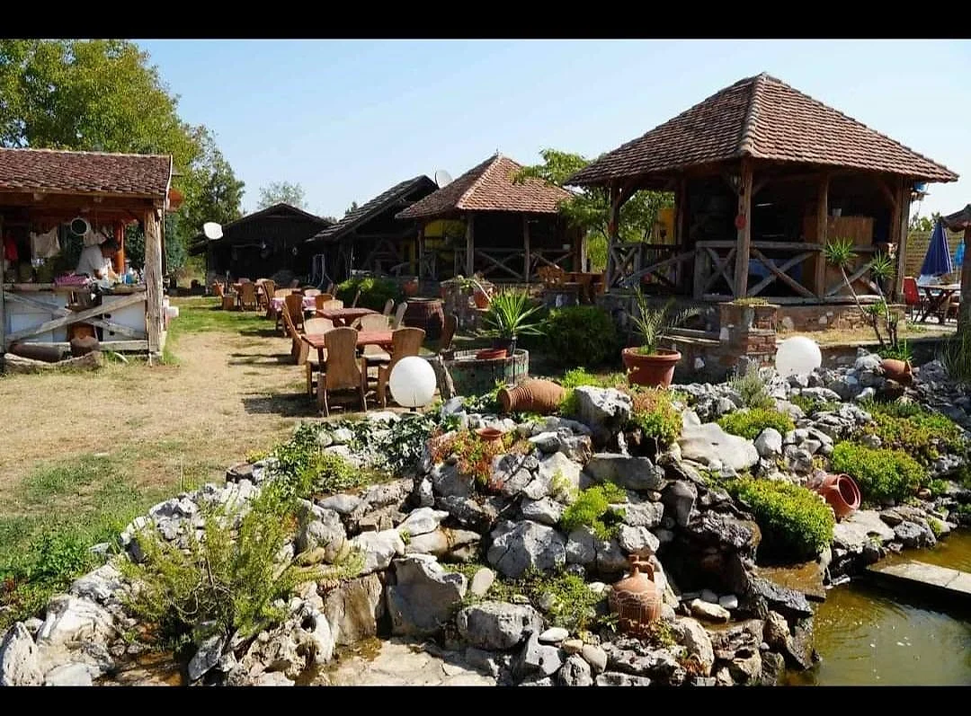 Bašta etno sela sa jezercem i drvenim brvnarama